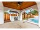 Covered poolside patio featuring a wood ceiling, an outdoor grill, and rod iron gate at 833 S Toltec --, Mesa, AZ 85204