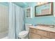 Well-lit bathroom with blue accents, decorative shower curtain, and updated fixtures at 848 W Keating Ave, Mesa, AZ 85210