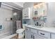 Updated bathroom features a glass-enclosed shower, modern vanity, and decorative mirror at 848 W Keating Ave, Mesa, AZ 85210