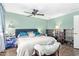 Bright bedroom features an inviting bed with blue headboard and ceiling fan at 848 W Keating Ave, Mesa, AZ 85210