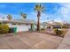 Single-story house with a two car garage, rock landscaping, green trim and palm trees in the front yard at 848 W Keating Ave, Mesa, AZ 85210