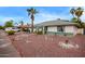 Well maintained single story house with rock landscaping, palm trees, and trimmed shrubbery, with green trim at 848 W Keating Ave, Mesa, AZ 85210