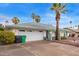 A well maintained single story house with rock landscaping, two car garage, palm trees and green trim at 848 W Keating Ave, Mesa, AZ 85210