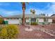 Charming single-story home featuring a lush, low-maintenance yard, palm trees, and a well-manicured lawn at 848 W Keating Ave, Mesa, AZ 85210