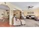 An open-concept living room with a ceiling fan, plush carpet, and an open floor plan leads to the dining room at 848 W Keating Ave, Mesa, AZ 85210