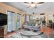 This living room with a ceiling fan, opens up to the kitchen and has direct access to the pool at 848 W Keating Ave, Mesa, AZ 85210