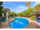 Inviting backyard pool featuring lush landscaping, mature trees, and a serene outdoor space perfect for relaxation and entertainment at 848 W Keating Ave, Mesa, AZ 85210