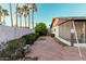 Spacious backyard with brick-paved area, privacy wall, and mature trees, perfect for outdoor activities and relaxation at 906 N Roosevelt Cir, Scottsdale, AZ 85257