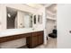 Bathroom with a large mirror above a built-in vanity and view to closet at 906 N Roosevelt Cir, Scottsdale, AZ 85257