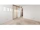 Clean bedroom featuring neutral carpet, sliding closet, and white door at 906 N Roosevelt Cir, Scottsdale, AZ 85257