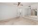 Bedroom featuring a ceiling fan, mirrors, and plush carpet at 906 N Roosevelt Cir, Scottsdale, AZ 85257