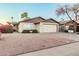 Charming single-story home with a well-maintained front yard and an attached two-car garage at 906 N Roosevelt Cir, Scottsdale, AZ 85257