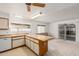 Bright kitchen features an island and sliding glass door to the backyard at 906 N Roosevelt Cir, Scottsdale, AZ 85257