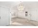 Bright living room featuring plush carpet, white walls, and a decorative chandelier at 906 N Roosevelt Cir, Scottsdale, AZ 85257