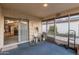 Enclosed screened porch with blue carpet, sliding door access, and plentiful natural light for relaxing or storage at 906 N Roosevelt Cir, Scottsdale, AZ 85257