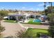 Aerial view of a private backyard with a pool, outdoor seating, and putting green, perfect for entertaining at 10050 N 58Th St, Paradise Valley, AZ 85253