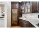 Stylish bar area with a wine fridge, sink, counterspace, and custom cabinetry at 10050 N 58Th St, Paradise Valley, AZ 85253