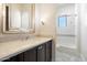 Bright bathroom features a modern vanity with stone countertop and tiled bathtub and shower combo at 10050 N 58Th St, Paradise Valley, AZ 85253