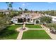Elegant front exterior with manicured lawn, fountain, and beautiful landscaping at 10050 N 58Th St, Paradise Valley, AZ 85253
