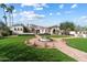 Stately home showcasing lush landscaping, a circular driveway, and an elegant fountain, exuding curb appeal at 10050 N 58Th St, Paradise Valley, AZ 85253