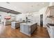 Bright open kitchen featuring double islands, stainless steel appliances, and plenty of counter space at 10050 N 58Th St, Paradise Valley, AZ 85253
