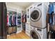 Convenient laundry room with stacked washer/dryer and built-in shelving at 10050 N 58Th St, Paradise Valley, AZ 85253