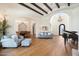 Spacious living room with open archways, elegant chandeliers, and hardwood flooring at 10050 N 58Th St, Paradise Valley, AZ 85253