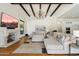 Comfortable living room with a fireplace, coffered ceiling, chandelier, and large sectional sofa at 10050 N 58Th St, Paradise Valley, AZ 85253