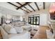 Open concept living room featuring coffered ceiling, fireplace, seamless access to backyard and kitchen at 10050 N 58Th St, Paradise Valley, AZ 85253