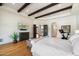 Large main bedroom with decorative ceiling beams, light walls, hardwood flooring and a tv at 10050 N 58Th St, Paradise Valley, AZ 85253