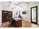 Bright home office with coffered ceiling, hardwood floors, built-in shelving, and a large executive desk at 10050 N 58Th St, Paradise Valley, AZ 85253