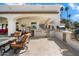 Elegant outdoor kitchen equipped with modern appliances, stone countertops, and seating, perfect for al fresco dining at 10050 N 58Th St, Paradise Valley, AZ 85253