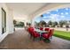 Spacious covered patio with dining area, offering views of the pool and beautifully landscaped backyard at 10050 N 58Th St, Paradise Valley, AZ 85253