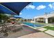 Resort-style pool with fountain features, sun loungers, and a shaded swing for ultimate relaxation at 10050 N 58Th St, Paradise Valley, AZ 85253