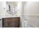 Elegant powder room featuring an ornate mirror, wall sconces, wainscoting, and designer fixtures at 10050 N 58Th St, Paradise Valley, AZ 85253