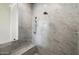 Close up of tiled marble shower with tiled seating area and adjustable shower head at 10050 N 58Th St, Paradise Valley, AZ 85253