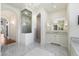 Elegant bathroom with glass door walk in shower, marble tiling and marble floor at 10050 N 58Th St, Paradise Valley, AZ 85253