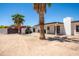 An outdoor kitchen sits in the backyard of this home, complemented by covered patio and desert landscape at 10105 E Cactus Rd, Scottsdale, AZ 85260