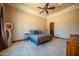 A spacious bedroom with a ceiling fan, neutral tones, and ample natural light at 10105 E Cactus Rd, Scottsdale, AZ 85260