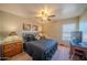 Comfortable bedroom with a ceiling fan, a large window, and natural light at 10105 E Cactus Rd, Scottsdale, AZ 85260