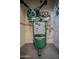 Close-up of a Champion air compressor in a well-lit utility room of the garage at 10105 E Cactus Rd, Scottsdale, AZ 85260