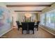 Elegant dining room with a stylish chandelier, large windows, and views of the outdoors at 10105 E Cactus Rd, Scottsdale, AZ 85260