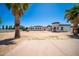 Expansive property featuring tile roof, desert landscape, porte-cochere, and a circular tower entryway at 10105 E Cactus Rd, Scottsdale, AZ 85260