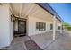 Inviting front entrance with a covered porch, a decorative door, and charming exterior lighting at 10105 E Cactus Rd, Scottsdale, AZ 85260