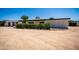 Charming single-story home featuring a desert landscape, neutral color palette, and mature trees at 10105 E Cactus Rd, Scottsdale, AZ 85260