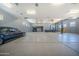 Large garage with car lifts and multiple cars is perfect for auto enthusiasts or collectors at 10105 E Cactus Rd, Scottsdale, AZ 85260