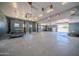 The garage has two car lifts, abundant natural light, and a spacious work area at 10105 E Cactus Rd, Scottsdale, AZ 85260