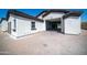 A large garage with an open door and a brick paved driveway on a sunny day at 10105 E Cactus Rd, Scottsdale, AZ 85260