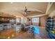 Spacious living area with travertine floors, a vaulted ceiling, a wet bar, and lots of natural light at 10105 E Cactus Rd, Scottsdale, AZ 85260