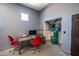 Garage office with a desk, rolling chairs, computer and printer next to an air compressor at 10105 E Cactus Rd, Scottsdale, AZ 85260